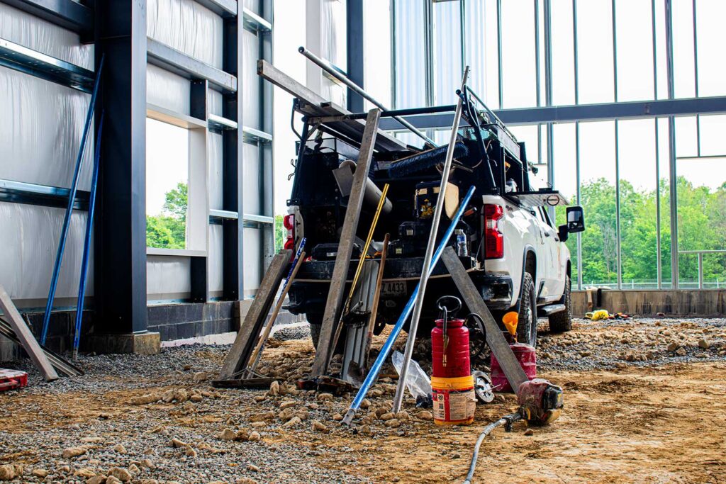 Truck parked inside North Jackson warehouse with supplies leaned up against