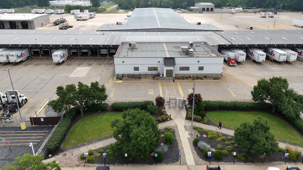 FedEx Delivery location with semi-trucks, parking lot, landscaping