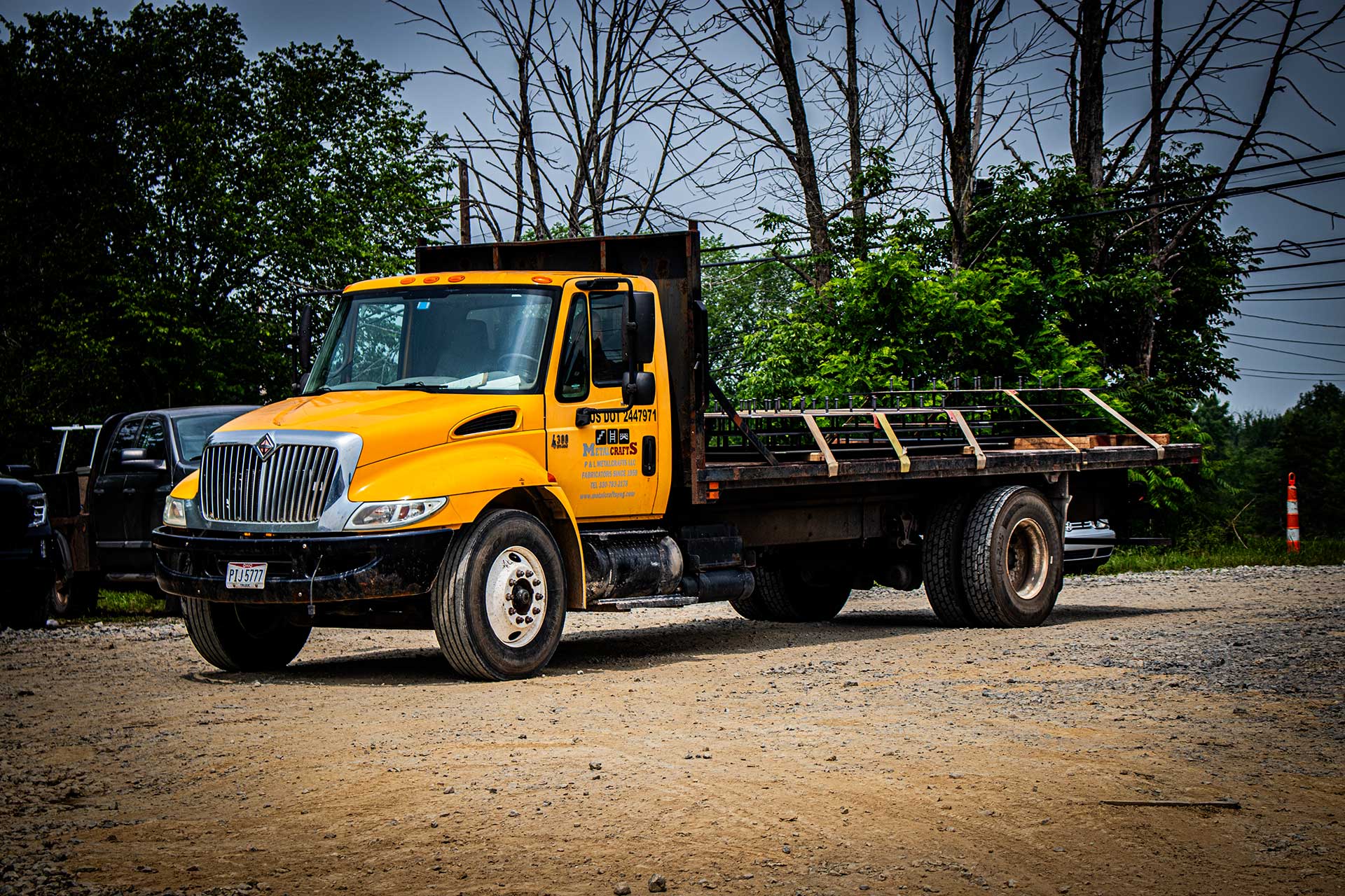 Top Property Holdings truck outside on gravel and dirt area